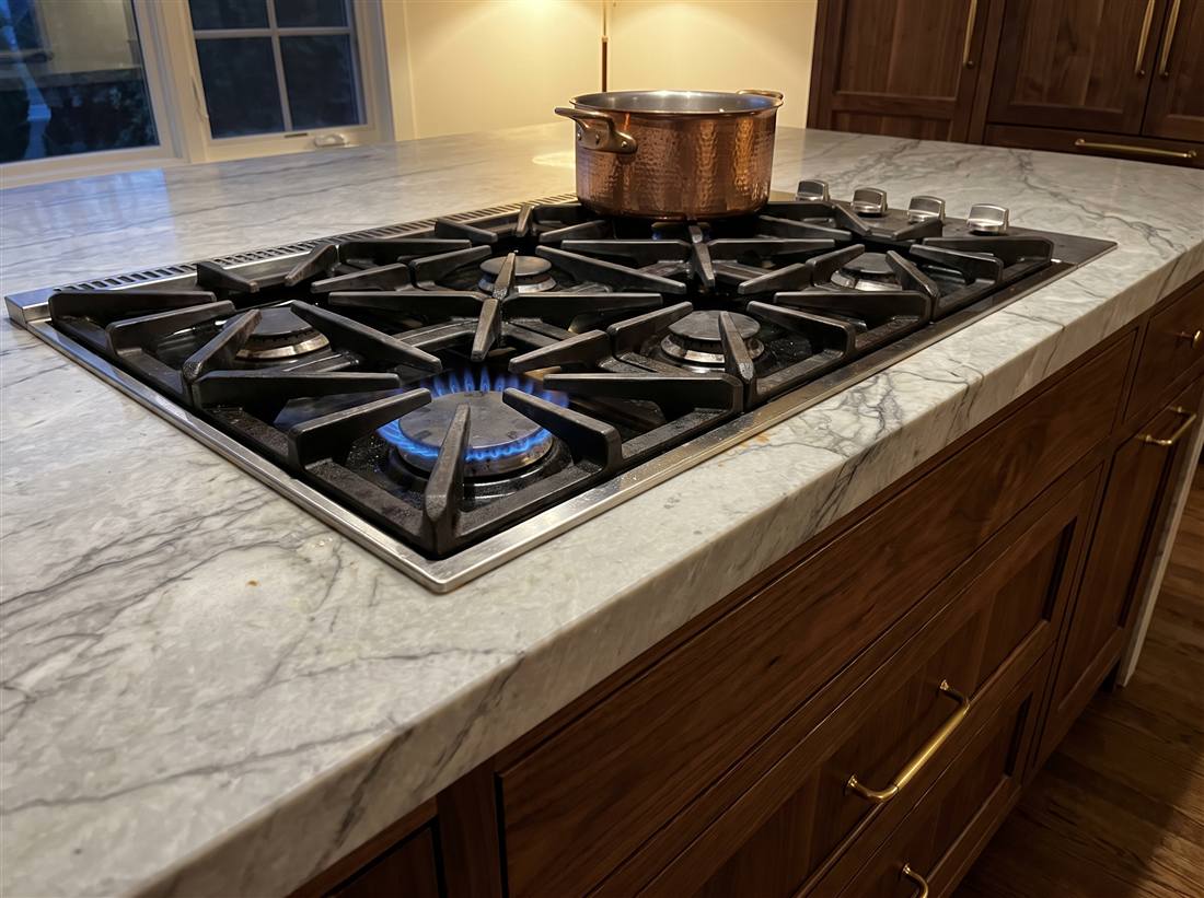 Gas cooktop with star-shaped burners set in marble
